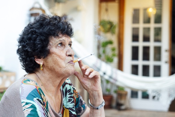 close up of senior woman smoking