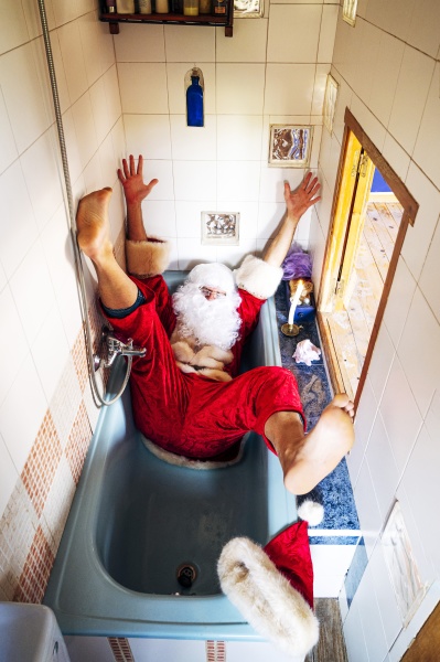 man wearing santa claus costume falling
