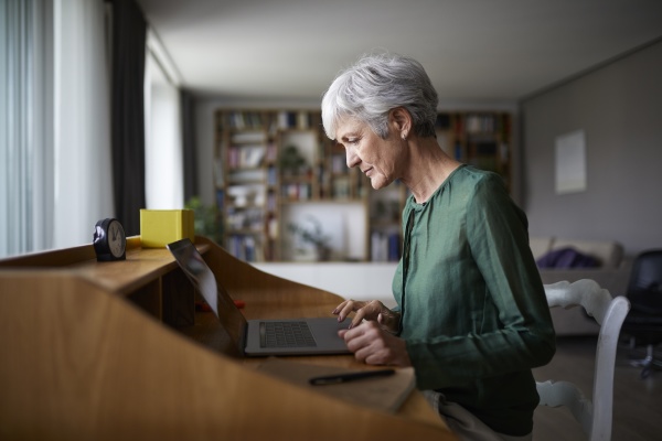 active senior woman concentrating while working