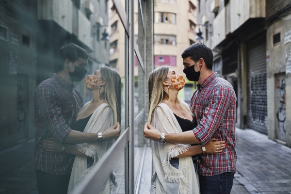 refection of couple embracing with protective