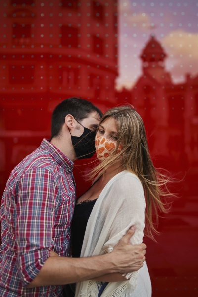 couple kissing with protective face mask