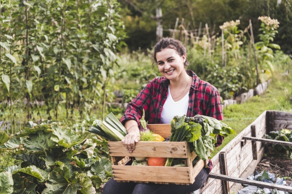smiling young woman with vegetables in