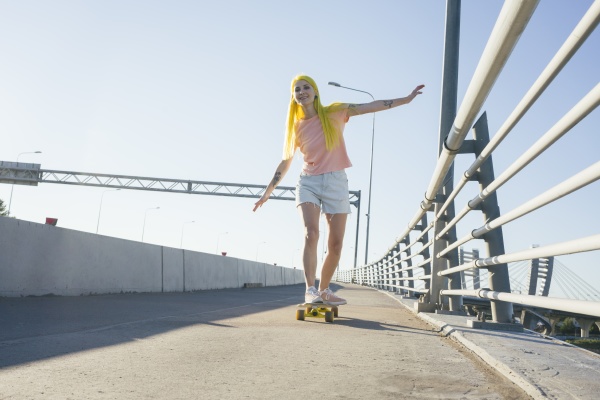 woman enjoying while skating on skateboard