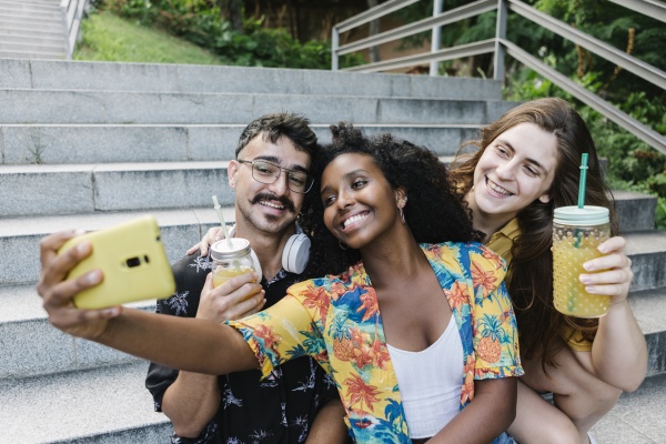friends taking selfie on smart phone
