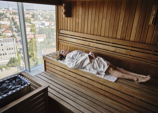 senior woman relaxing in wooden sauna