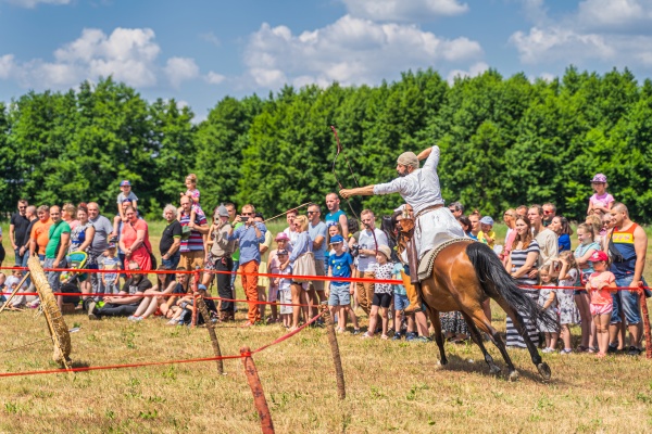 horseback archery show with flying arrow