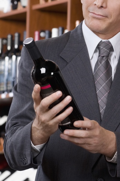 businessman holding a wine bottle
