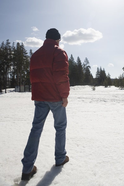 man walking in snow yellowstone