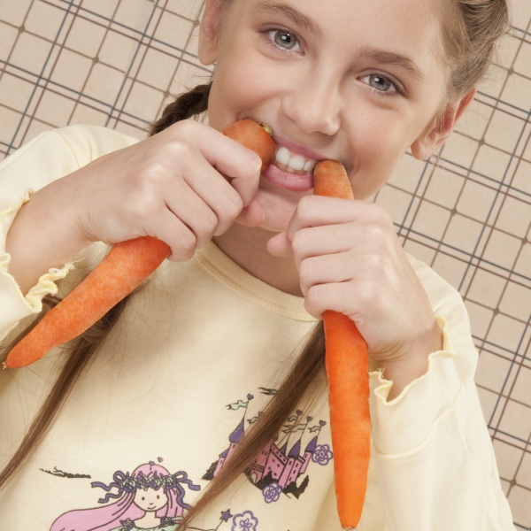portrait of a girl holding carrots