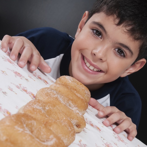 boy with a line of donuts