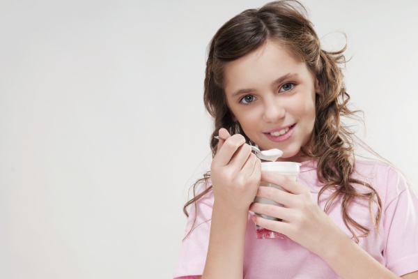 portrait of a girl eating yogurt