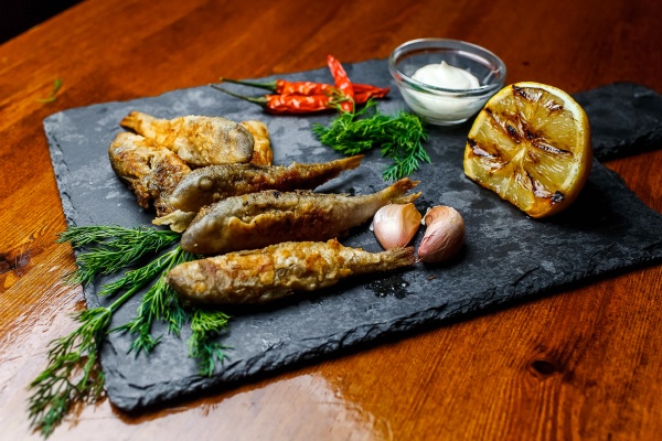 fried fish on chopping board with