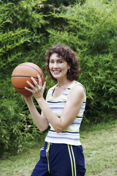 mature woman holding a basketball