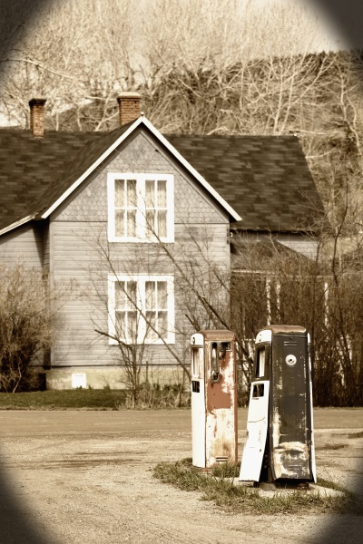 abandoned gas pumps near a house