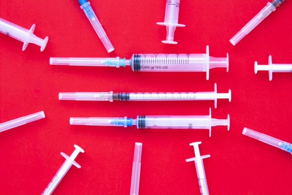 different syringes injections on a red