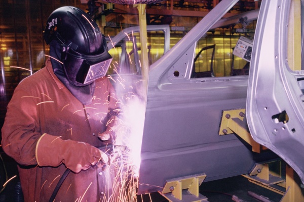 workers weld car bodies chrysler