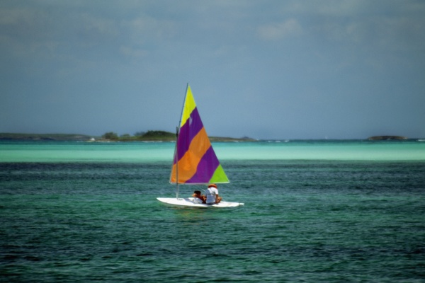 a colorful sailboat on the tranquil