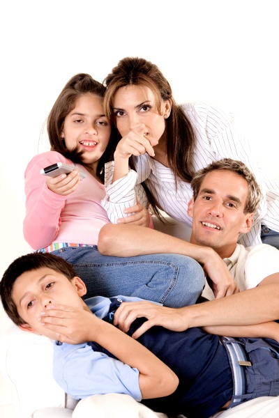 parents watching television with their son
