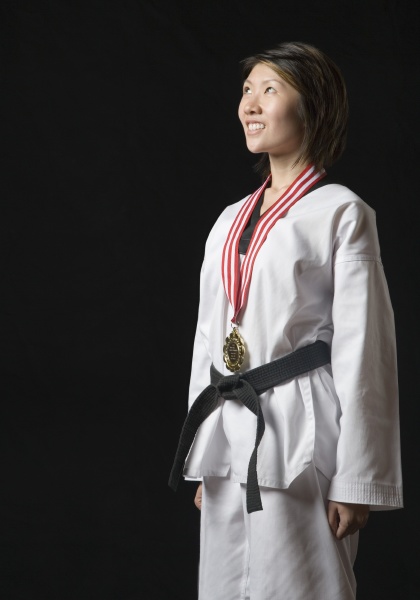 young woman standing with a medal