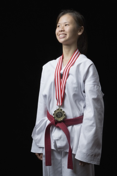 young woman standing with a medal