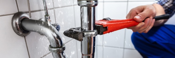 plumber repairing sink pipe leakage