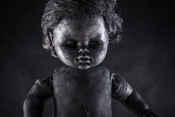creepy doll in the dark