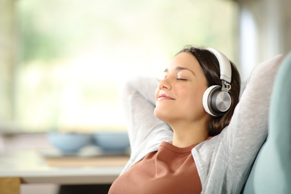 woman relaxing listening to music sitting