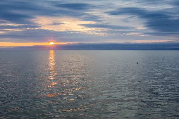 sunset over the water of kotzebue