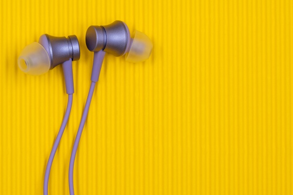 purple audio earphones on the yellow