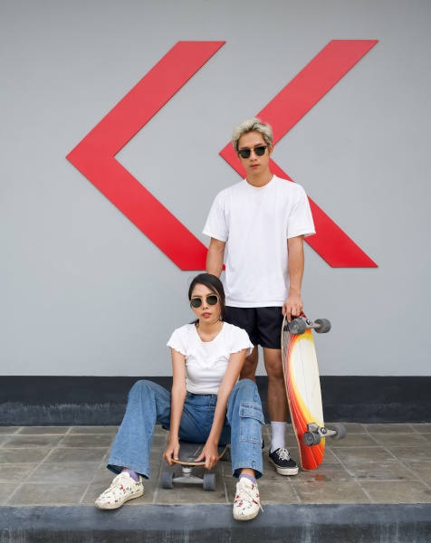 asian couple resting after skateboarding