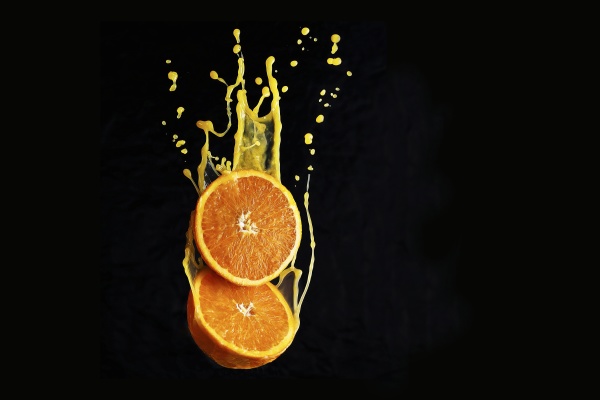 orange flying in the juice splashes