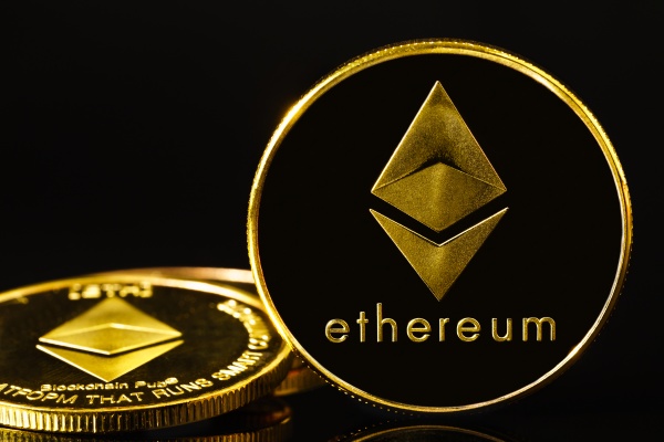 golden coin with ethereum symbol on