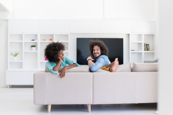 young multiethnic couple in living room