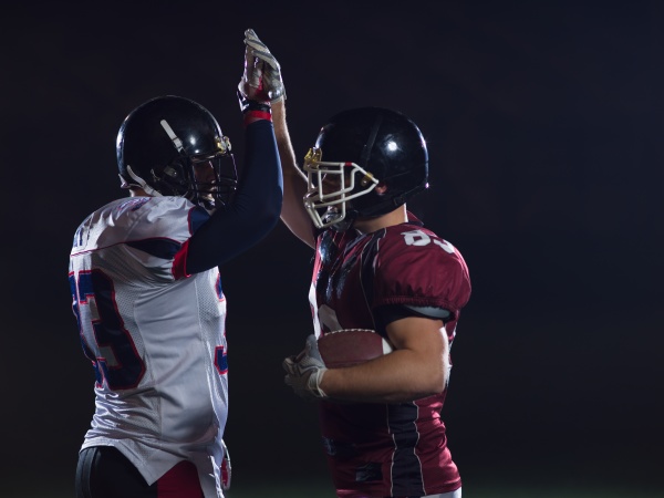 american football players celebrating after scoring a - Stock image