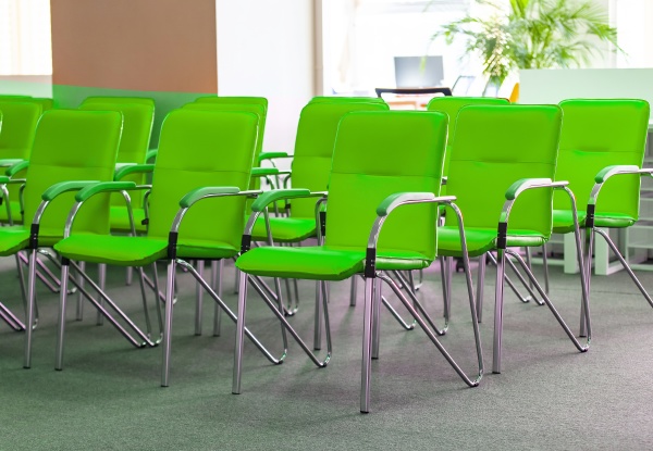 row of green office chairs in