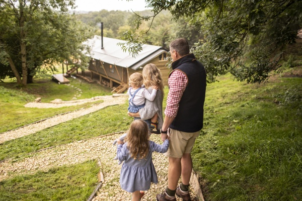 family walking on path above cabin