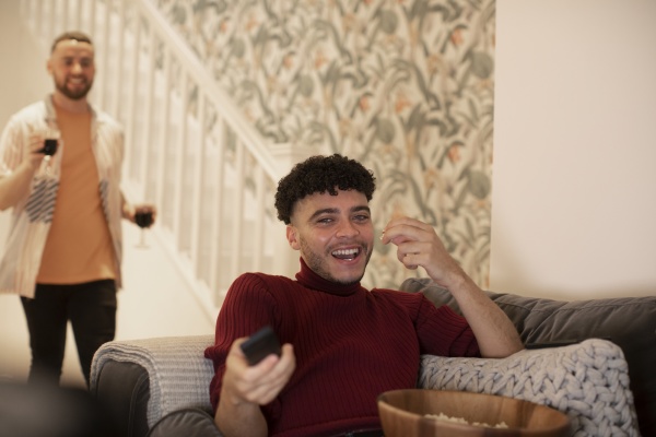 happy young man with remote control
