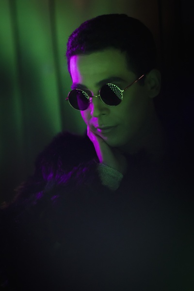 stylish young man wearing sunglasses in