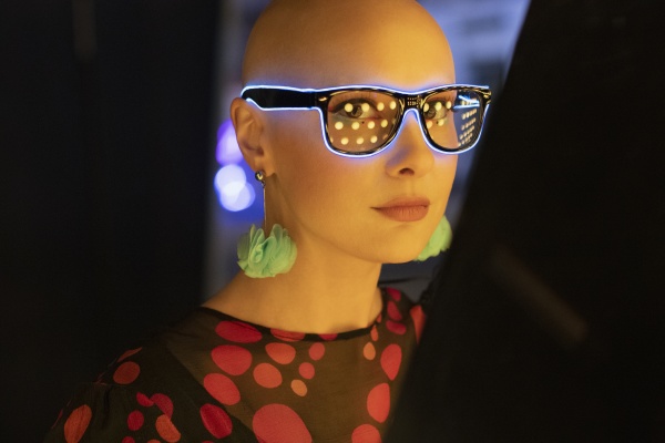 portrait stylish woman in neon glasses