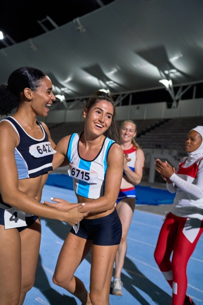 happy female track and field relay
