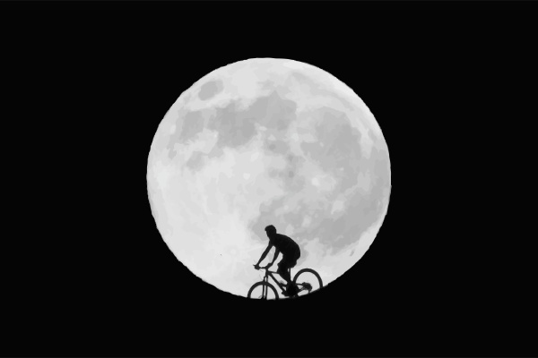 the cyclist rides against the background