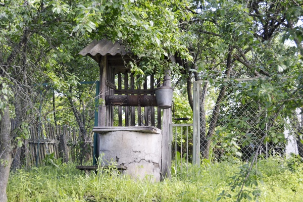 old well with iron bucket on