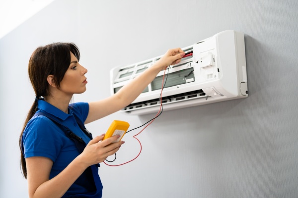 electrician repairing air conditioner ac