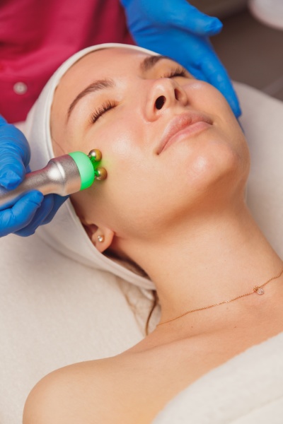 young woman getting ultrasound skin cleansing