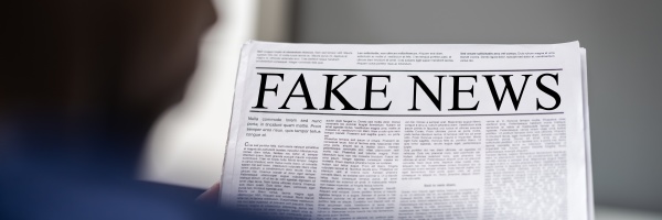 african man reading fake news headline