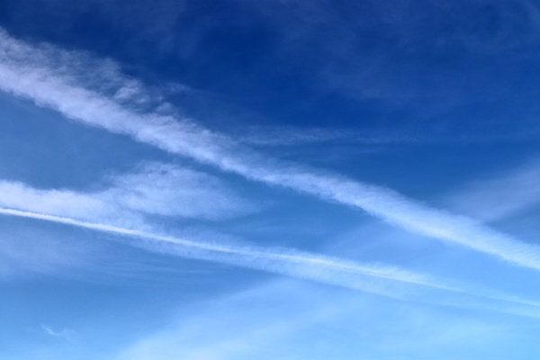 aircraft condensation contrails in the blue