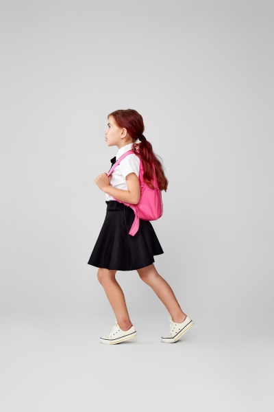 adorable schoolgirl with backpack back
