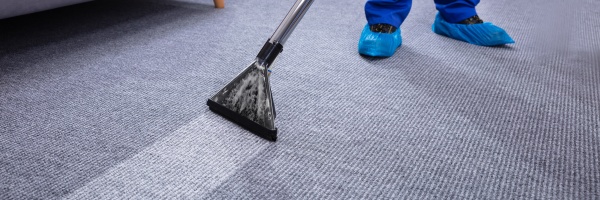 male janitor cleaning carpet