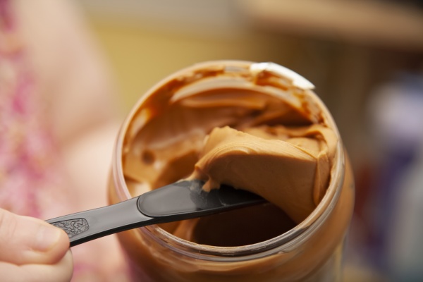 digging peanut butter from a jar