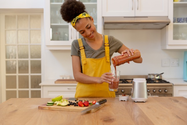 mixed race woman pouring a healthy